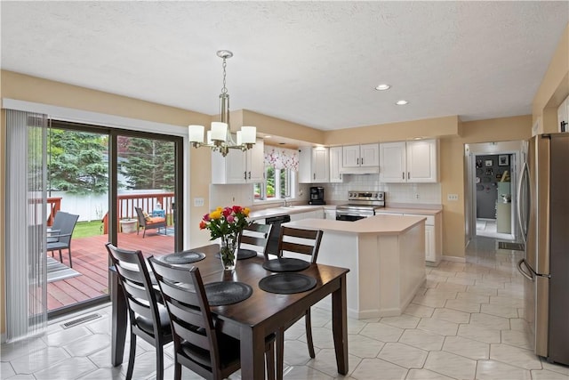 106 Shingle Landing Dr, Irondequoit, NY 14609 - dining room featuring a chandelier, healthy amount of natural light, recessed lighting, a textured ceiling, and baseboards