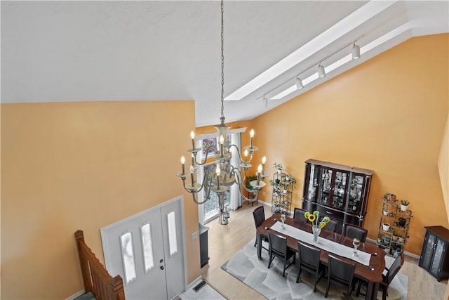 106 Shingle Landing Dr, Irondequoit, NY 14609 - entryway featuring a chandelier, lofted ceiling, and baseboards