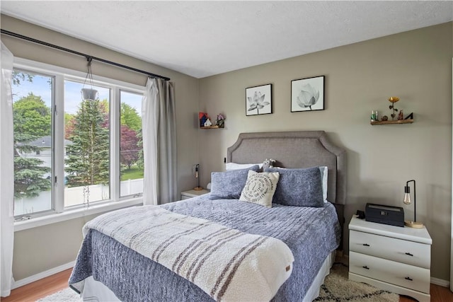 106 Shingle Landing Dr, Irondequoit, NY 14609 - bedroom with baseboards and wood finished floors