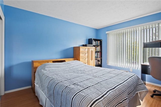 106 Shingle Landing Dr, Irondequoit, NY 14609 - bedroom with baseboards and wood finished floors
