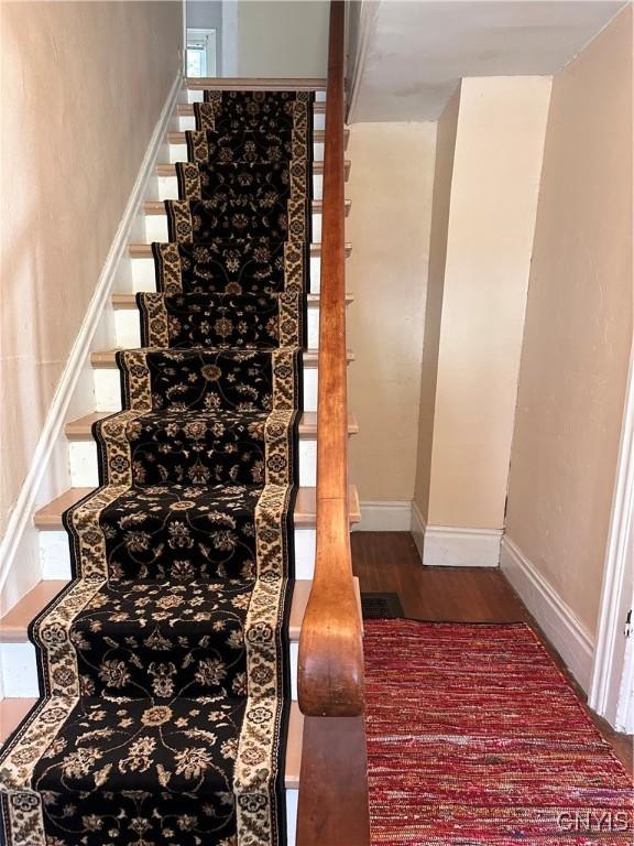 28 Payne St, Hamilton, NY 13346 - staircase featuring wood finished floors and baseboards