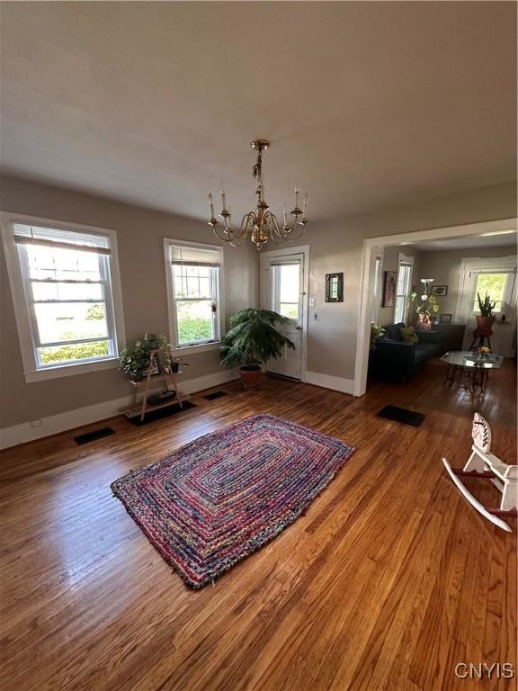 28 Payne St, Hamilton, NY 13346 - dining area with a chandelier, wood finished floors, and baseboards