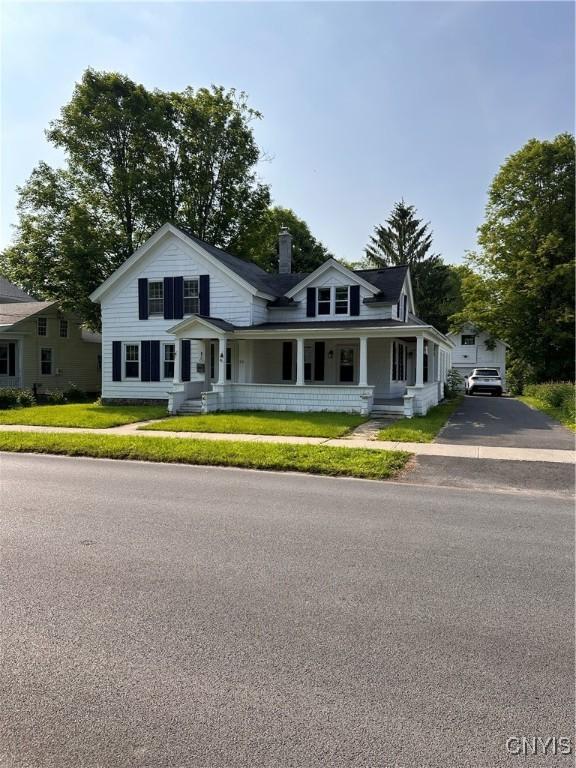 28 Payne St, Hamilton, NY 13346 - view of front of house featuring covered porch and a chimney