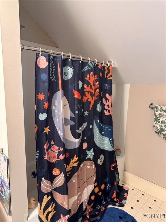 28 Payne St, Hamilton, NY 13346 - full bath featuring tile patterned flooring, vaulted ceiling, and baseboards