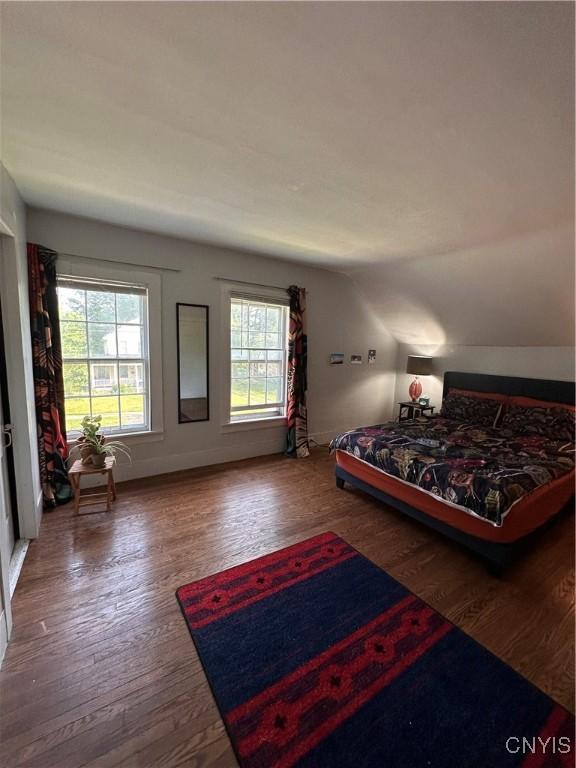 28 Payne St, Hamilton, NY 13346 - bedroom featuring wood finished floors, vaulted ceiling, and baseboards