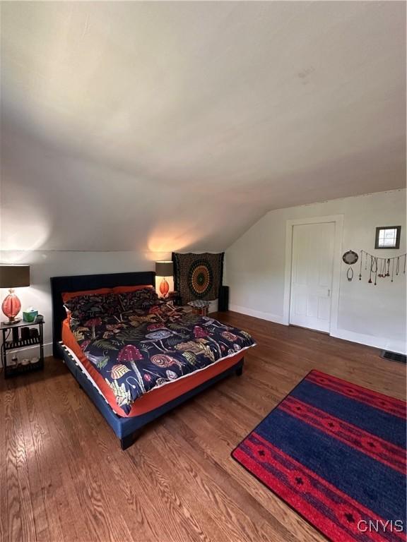 28 Payne St, Hamilton, NY 13346 - bedroom with wood finished floors, vaulted ceiling, and baseboards