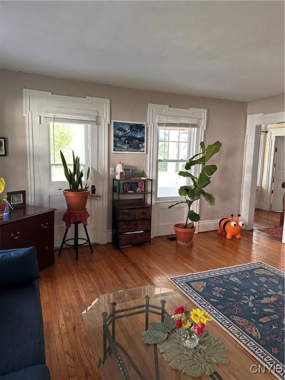28 Payne St, Hamilton, NY 13346 - living area featuring wood finished floors, healthy amount of natural light, and baseboards