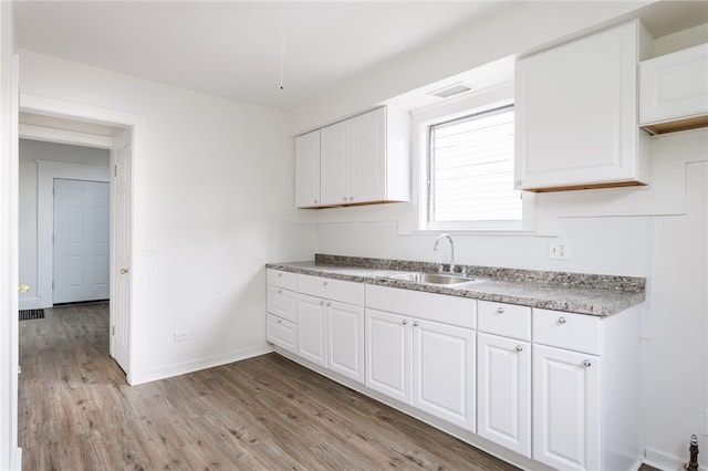 65 Hoff St, Rochester, NY 14621 - kitchen with a sink, light wood finished floors, white cabinets, baseboards, and light countertops