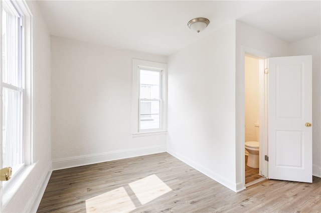 65 Hoff St, Rochester, NY 14621 - unfurnished bedroom featuring light wood-style flooring, baseboards, and ensuite bath