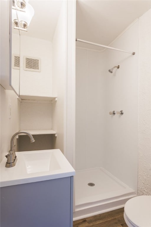 65 Hoff St, Rochester, NY 14621 - full bathroom featuring a shower stall, toilet, vanity, and wood finished floors