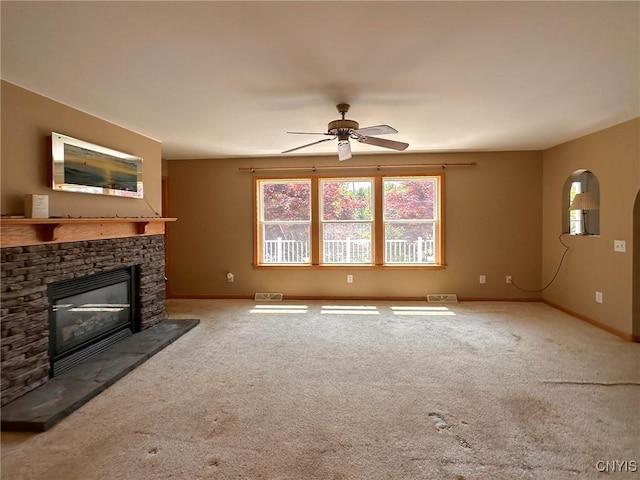 7554 Camroden Rd, Floyd, NY 13440 - unfurnished living room featuring ceiling fan, a fireplace, baseboards, and carpet