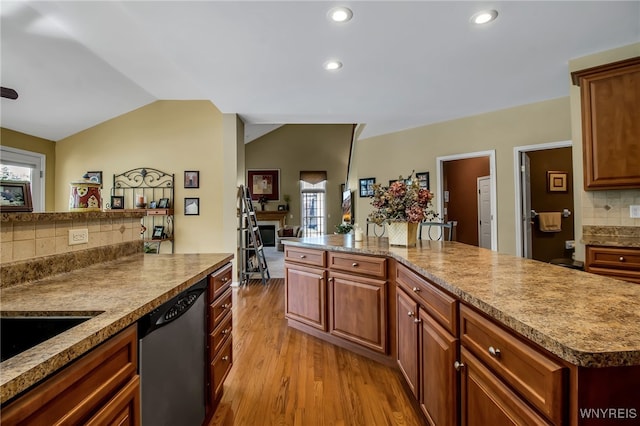 9100 Beech Meadow Ct, Clarence, NY 14032 - kitchen with dishwasher, vaulted ceiling, light wood-type flooring, backsplash, and recessed lighting