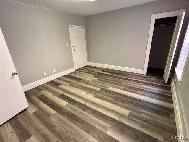 639 17th St, Niagara Falls, NY 14301 - unfurnished bedroom with dark wood-style floors and baseboards