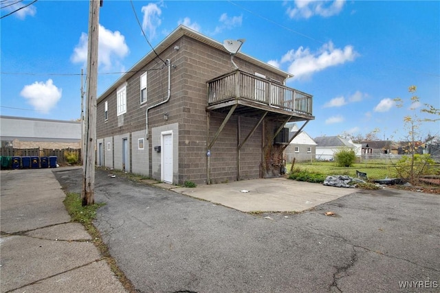 639 17th St, Niagara Falls, NY 14301 - view of side of home featuring concrete block siding and a balcony