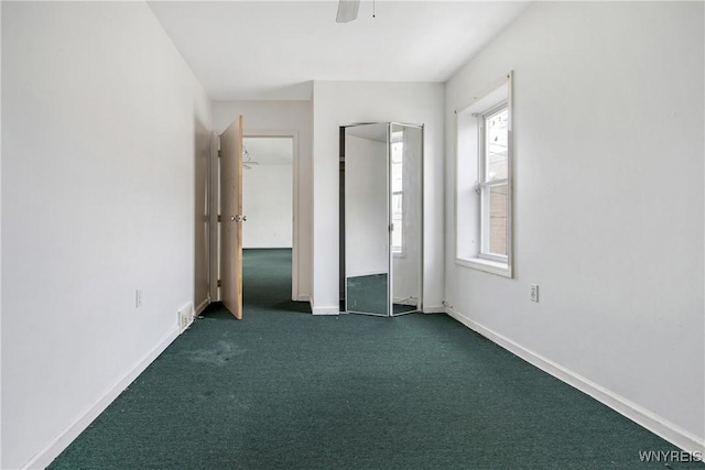 639 17th St, Niagara Falls, NY 14301 - unfurnished bedroom with dark colored carpet, baseboards, and a ceiling fan