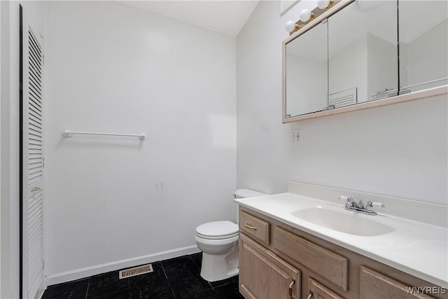 639 17th St, Niagara Falls, NY 14301 - bathroom with a closet, toilet, vanity, and baseboards