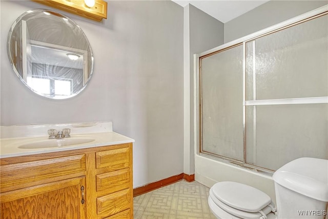 639 17th St, Niagara Falls, NY 14301 - bathroom featuring toilet, vanity, enclosed tub / shower combo, and baseboards