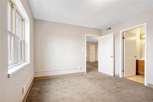 639 17th St, Niagara Falls, NY 14301 - unfurnished bedroom with carpet floors, baseboards, and ensuite bath
