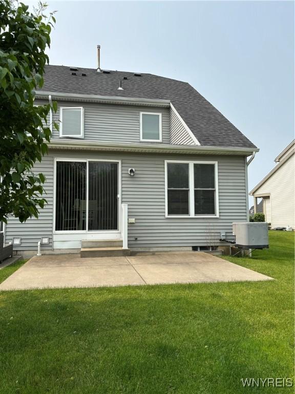 41 Brocton Dr, Lancaster, NY 14086 - rear view of house with a patio, a lawn, central air condition unit, and a shingled roof