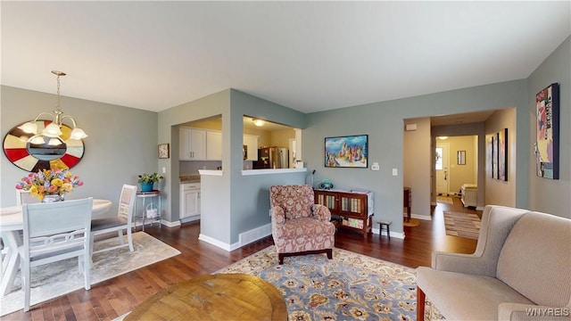 41 Brocton Dr, Lancaster, NY 14086 - living area with dark wood finished floors, a chandelier, and baseboards
