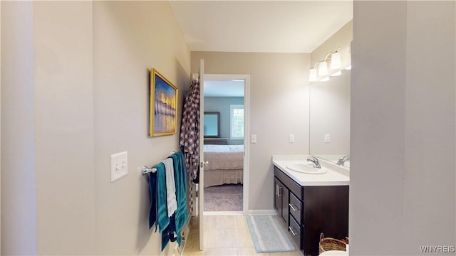41 Brocton Dr, Lancaster, NY 14086 - ensuite bathroom with vanity, tile patterned flooring, and baseboards