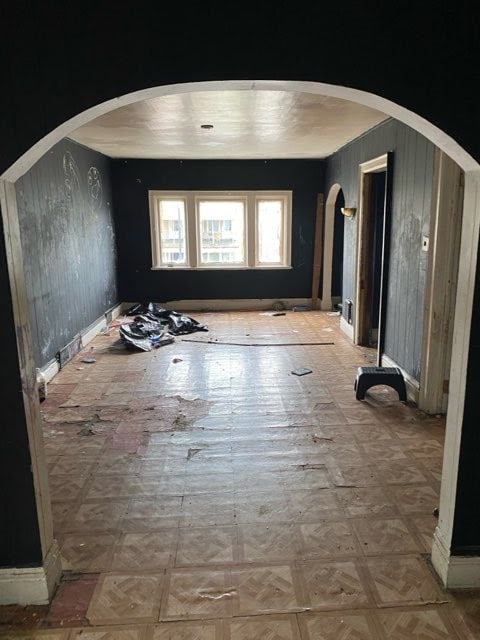 130 E Delavan Ave Unit N, Buffalo, NY 14208 - spare room with arched walkways and wooden walls