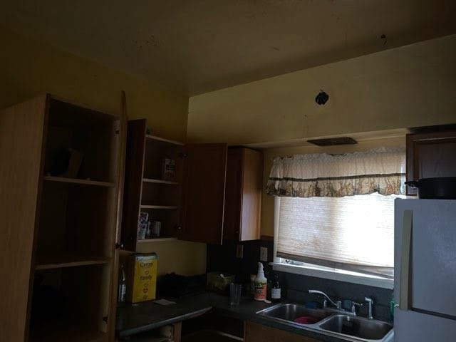 130 E Delavan Ave Unit N, Buffalo, NY 14208 - kitchen featuring a sink, freestanding refrigerator, and dark countertops