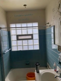 130 E Delavan Ave Unit N, Buffalo, NY 14208 - bathroom featuring a bathtub, toilet, vanity, and a shower