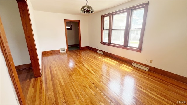 1324 Butternut St, Utica, NY 13502 - empty room featuring light wood-style flooring, baseboard heating, and baseboards