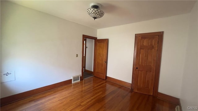 1324 Butternut St, Utica, NY 13502 - unfurnished bedroom featuring wood finished floors and baseboards