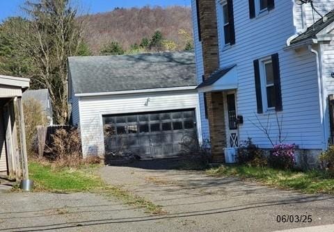 46 Kirby St, Bainbridge, NY 13733 - view of front of property with a garage, driveway, and a chimney