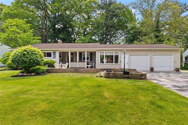 529 Backus Rd, Webster, NY 14580 - ranch-style home featuring covered porch, an attached garage, driveway, and a front lawn
