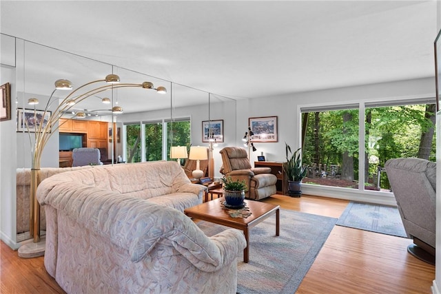 529 Backus Rd, Webster, NY 14580 - living room with plenty of natural light, wood finished floors, and a chandelier