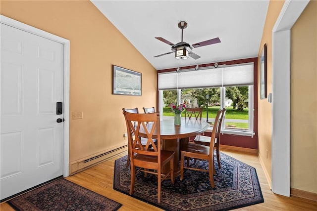 529 Backus Rd, Webster, NY 14580 - dining area featuring a ceiling fan, lofted ceiling, light wood-style floors, a baseboard heating unit, and baseboards