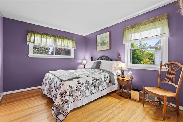 529 Backus Rd, Webster, NY 14580 - bedroom featuring multiple windows, wood finished floors, and baseboards