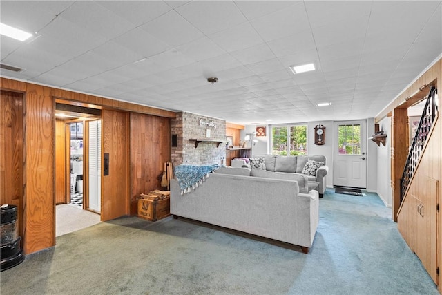 529 Backus Rd, Webster, NY 14580 - living room with wood walls, carpet floors, and stairs