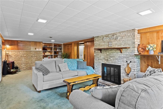 529 Backus Rd, Webster, NY 14580 - living room featuring wooden walls, carpet, and a fireplace