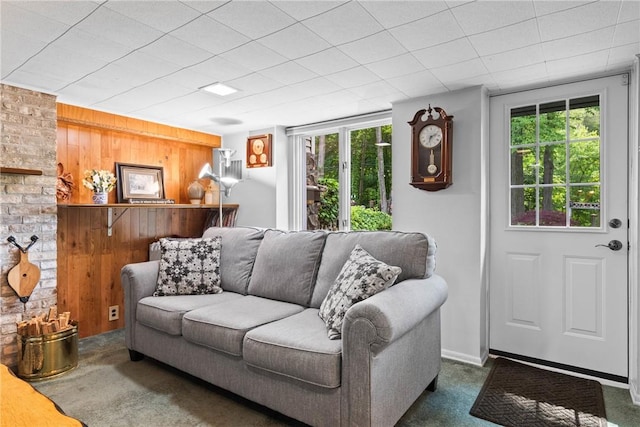 529 Backus Rd, Webster, NY 14580 - living room featuring dark colored carpet and wood walls