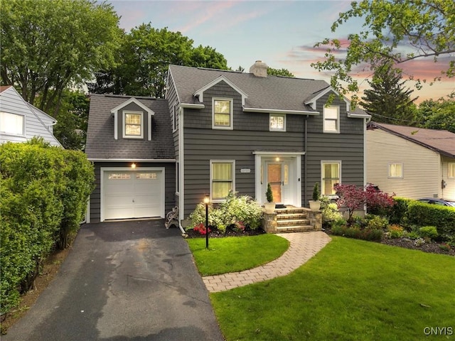 101 Doll Pkwy, Syracuse, NY 13214 - view of front facade with a lawn, roof with shingles, a chimney, and asphalt driveway
