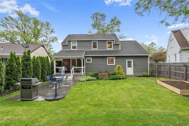 101 Doll Pkwy, Syracuse, NY 13214 - rear view of house featuring a patio area, a vegetable garden, a chimney, and roof with shingles