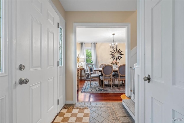 101 Doll Pkwy, Syracuse, NY 13214 - foyer featuring a chandelier, light tile patterned floors, inlaid floor details, and baseboards