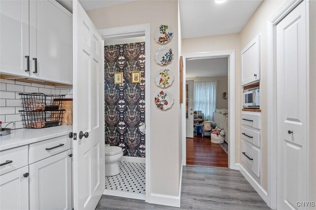 101 Doll Pkwy, Syracuse, NY 13214 - corridor with wood finished floors and baseboards