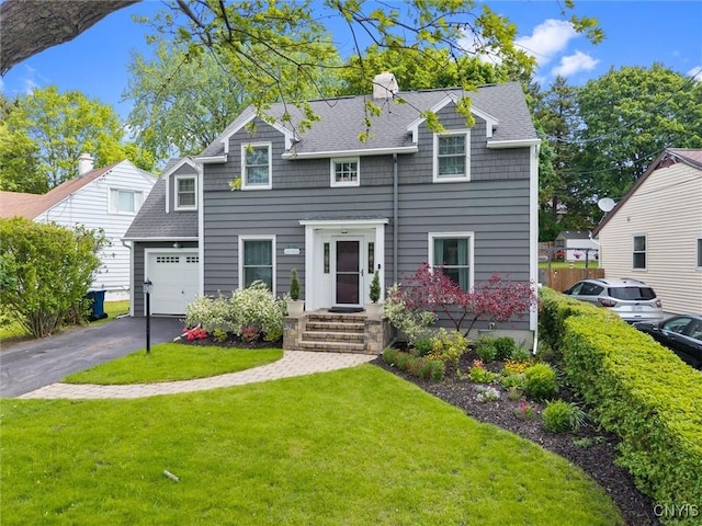 101 Doll Pkwy, Syracuse, NY 13214 - view of front of house with a garage, a front lawn, asphalt driveway, roof with shingles, and a chimney