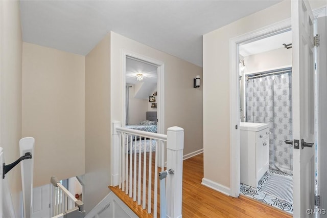 101 Doll Pkwy, Syracuse, NY 13214 - hallway featuring an upstairs landing, light wood-style floors, and baseboards