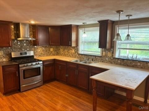2334 State Route 49th Hwy, West Monroe, NY 13167 - kitchen with wall chimney range hood, stainless steel gas range oven, a sink, and light wood-style flooring