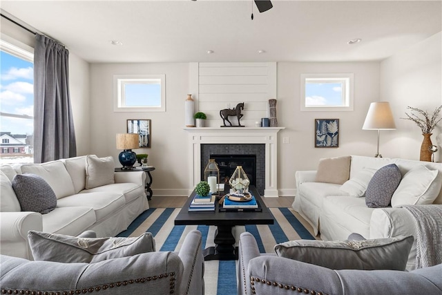 108 Chase Meadow Trl, Mendon, NY 14472 - living room featuring wood finished floors, baseboards, a ceiling fan, and a glass covered fireplace