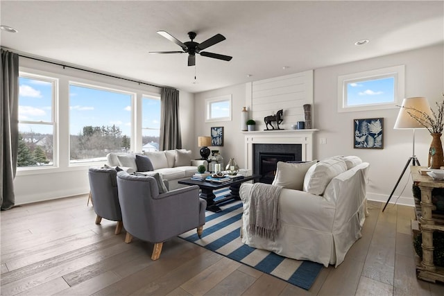 108 Chase Meadow Trl, Mendon, NY 14472 - living area featuring hardwood / wood-style flooring, a glass covered fireplace, plenty of natural light, a ceiling fan, and recessed lighting