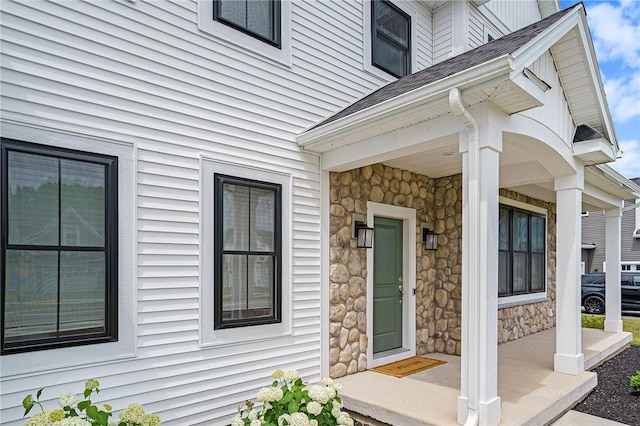 108 Chase Meadow Trl, Mendon, NY 14472 - entrance to property with covered porch, stone siding, and roof with shingles