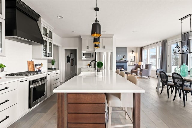 108 Chase Meadow Trl, Mendon, NY 14472 - kitchen featuring appliances with stainless steel finishes, a sink, light countertops, hardwood / wood-style flooring, and recessed lighting