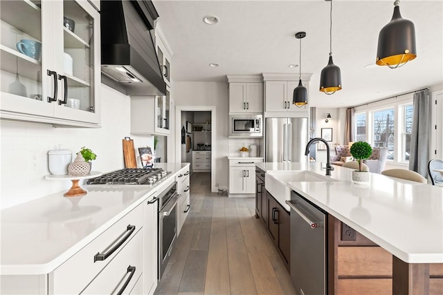 108 Chase Meadow Trl, Mendon, NY 14472 - kitchen featuring appliances with stainless steel finishes, custom exhaust hood, a sink, light countertops, and a large island with sink